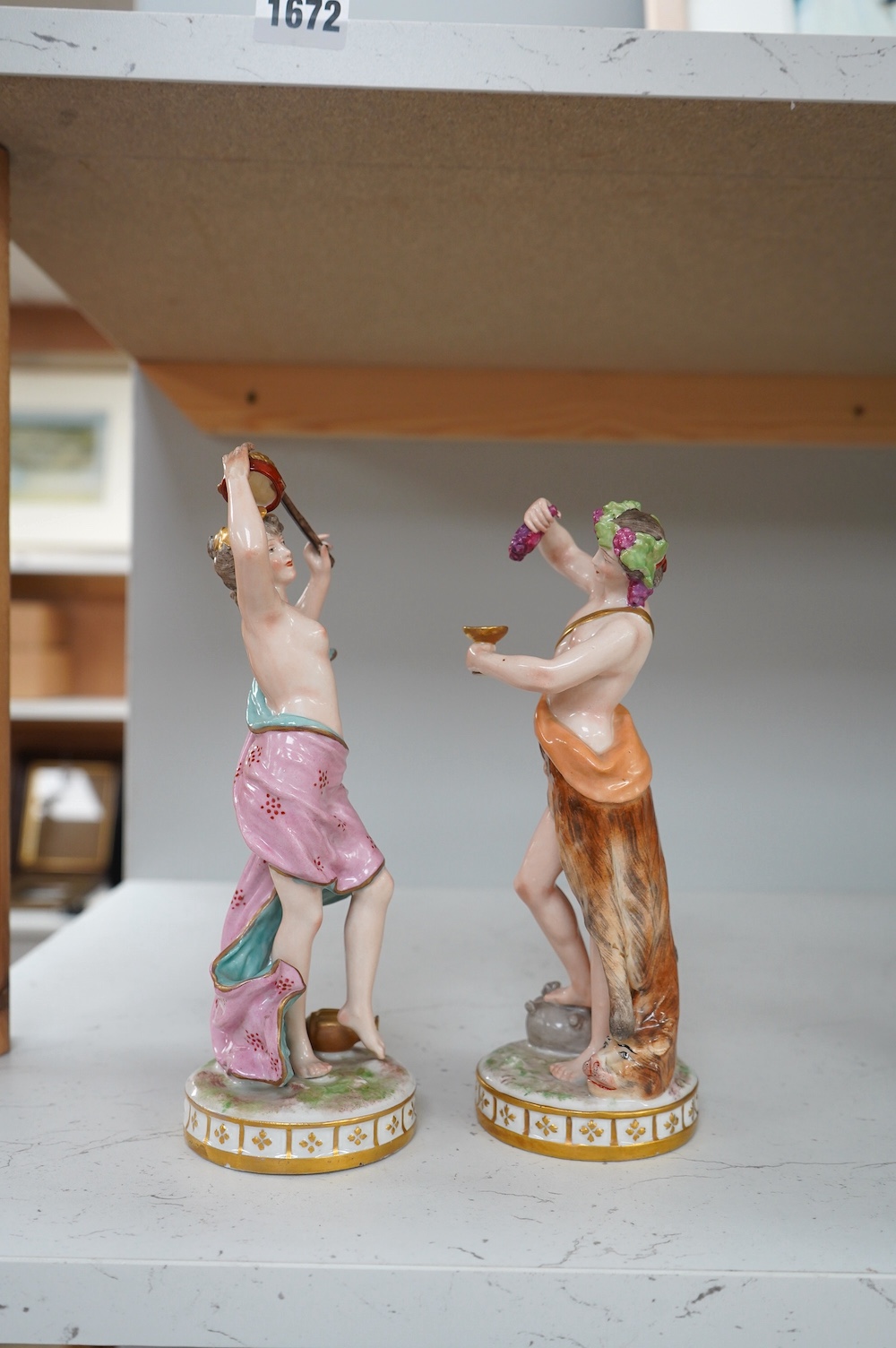 A pair of German porcelain figures, 22cm. Condition - fair to good